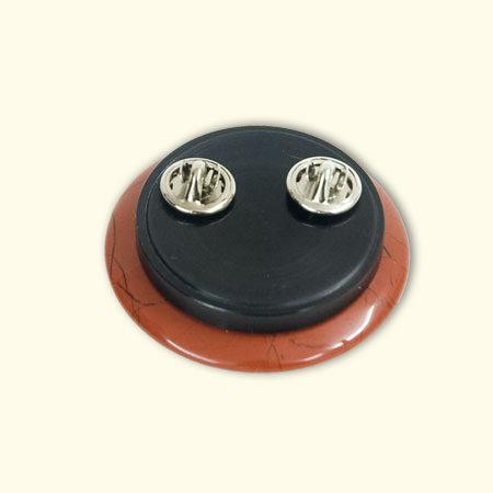 Achterkant van de Rouwknoop is het brocheplaatje erop gedraaid. Dit kan worden verwisseld voor het hangerplaatje en het reversspeldplaatje.